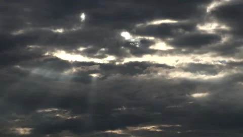 Dark clouds with bright sun beams - sky background - Time Lapse Stock Footage 153840386