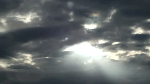 Dark clouds with bright sun beams - sky background with sunrays - Time Lapse Stock Footage 153840425
