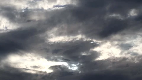 Dark clouds with bright sun beams - sky background with sunrays - Time Lapse Stock Footage 153840441