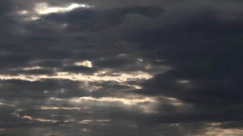 Dark clouds with bright sun beams - sky background, birds, sunrays - real time Stock Footage 153841498