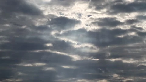 Dark clouds with bright sun beams - sky background, birds, sunrays - real time Stock Footage 153841871