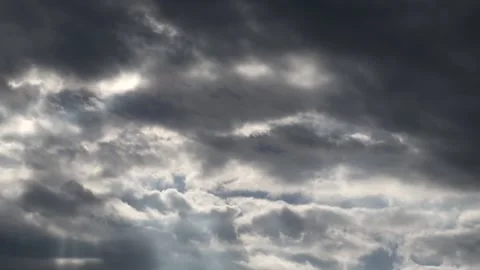 Dark clouds with bright sun beams - sky background with sunrays - Time Lapse Stock Footage 153842464
