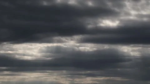 Dark clouds with bright sun beams - sky background with sunrays - Time Lapse Stock Footage 153842538