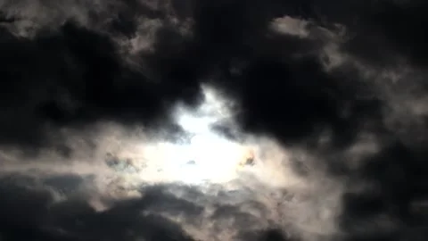 Dark clouds with bright sun beams - sky background with sunrays - Time Lapse Stock Footage 153842561