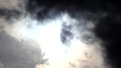 Dark clouds with bright sun beams - sky background with sunrays - Time Lapse Stock Footage 153843581