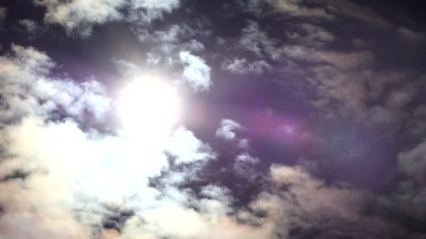Dark clouds with bright sun beams - sky background, sunrays - real time Stock Footage 153845146