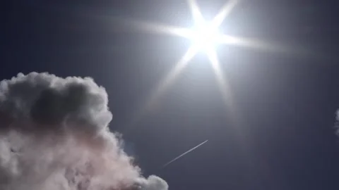 Dark clouds with bright sun beams - sky background, plane, sunrays - real time Stock Footage 153952379