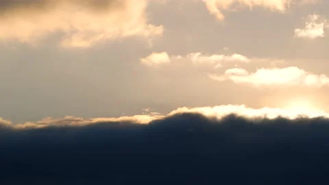 Dark clouds with bright sun beams - sky background, sunrise - real time Stock Footage 154688977