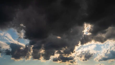 Dark clouds clearing sun rays shine through moving sky Stock Footage 334858029