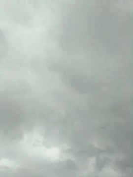 Dark clouds in the cold gray sky Stock Photos