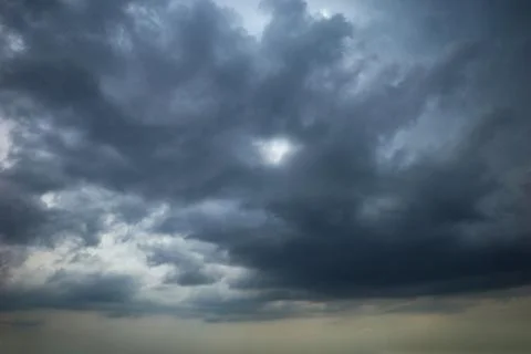 Dark clouds in the dramatic sky Stock Photos