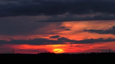 Dark clouds drifting by during a gorgeous sunset. timelapse Stock Footage 77576095