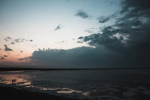 Dark clouds at dusk by the beach Stock Photos