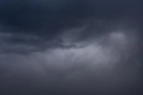 Dark clouds in the evening, a suitable thunderstorm, a dark beautiful sky in  Stock Photos