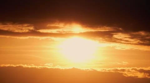 Dark clouds in the evening sunset sky with the setting sun, timelapse. Dramat Stock Photos