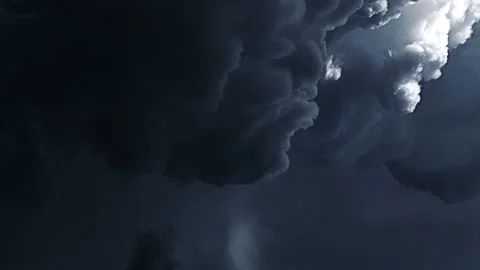 Dark clouds floating in the sky with a bolt of lightning Stock Footage 146813110