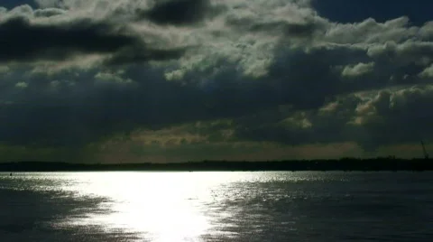 Dark clouds flowing across a fast moving river Stock Footage 628209