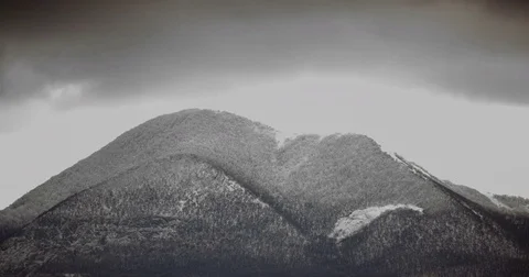 Dark clouds fly over the snow capped mountain Video stock 79382949