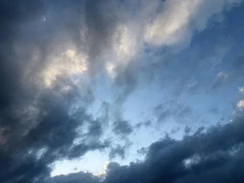 Dark Clouds Framing Bright Sunlight in Sky Stock Photos