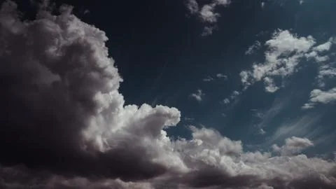 Dark clouds gliding through a dark sky Stock Photos