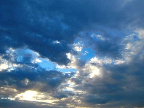 Dark clouds, illuminated by the sun. Stock Photos