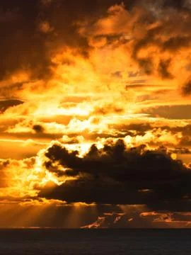 Dark clouds lit by bright sunset light Stock Photos