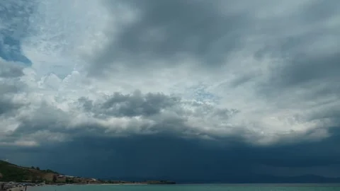Dark clouds loom above sea. Trani Ammouda, Greece Stock Footage 339619126