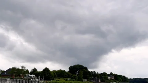 Dark Clouds Loom Over a Coastal Town on the North Sea, Threatening to Unleash 動画素材 297854413