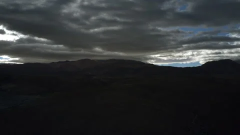 Dark Clouds Loom Over A Mountainous Landscape, Creating A Dramatic And 스톡 동영상 297521542