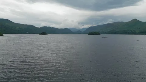 Dark clouds loom over quiet lake waters Stock Footage 345527902