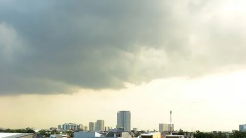 Dark clouds moved quickly over the city ahead of heavy rain. Copy space Stock Photos