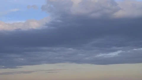 Dark clouds moving across the sky at sunset Video stock 344907976