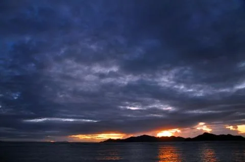 Dark clouds on the ocean during sunset. Seychelles Stock Photos