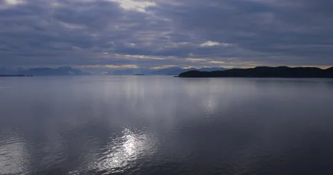 Dark clouds over Alaska Inside Passage-Light reflects off smooth water Stock Footage 208447192