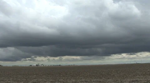 Dark clouds over flat land Stock Footage 936745