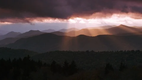 Dark clouds over the forest and mountain ranges at sunset Stock Footage 103398659