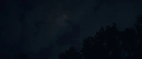 Dark clouds over the forest at night Stock Footage 242864973