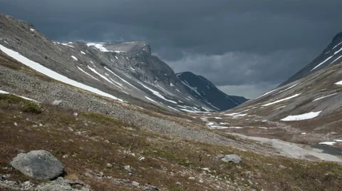 Dark clouds over the gloomy rocks light zoom-in Stock-Footage 64254184
