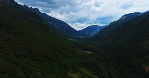 Dark Clouds Over Magical Green Vibrant Valley Sun Rays Aerial Descend Stock Footage 300446230