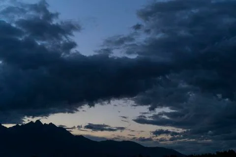 Dark Clouds Over Mountains After Sunset Stock Photos