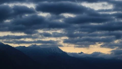 Dark clouds over mountains seen from Interlaken, Switzerland. Stock Photos