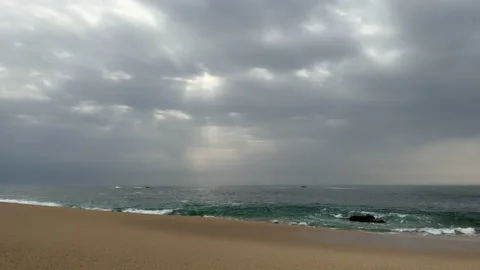 Dark clouds over ocean in spring with one small fishing boat on the waves Video stock 237754689