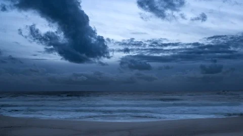 Dark clouds over ocean time lapse. Day to night transition on beach. Stock Footage 105926149