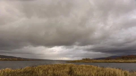 Dark clouds over the river. Stock Footage 56635819