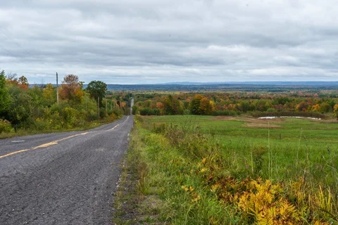 Dark clouds over road 스톡 동영상 128653664