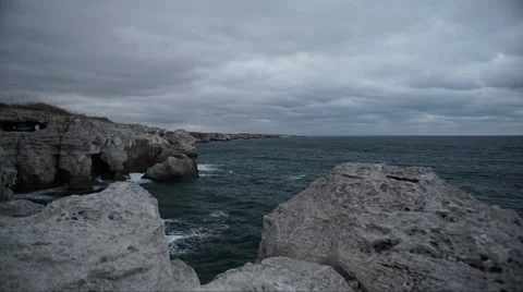 Dark Clouds over Sea Rocks Timelapse 4K Video stock 66561212