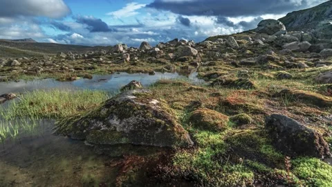 Dark clouds pass above the harsh Nordic landscape in a timelapse video. Stock Footage 270036798