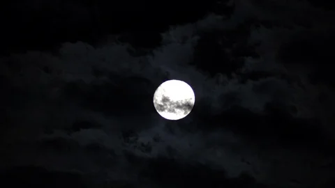 Dark clouds pass in front of the full moon on a spooky night. Stock Footage 99176780