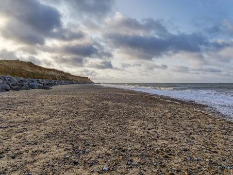 Dark clouds pass over a deserted Happisburgh beach in Norfolk Stock Photos