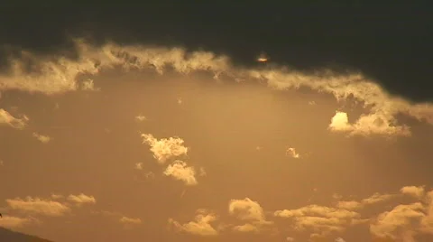 Dark clouds passing in front of the sun  Stock Footage 490900